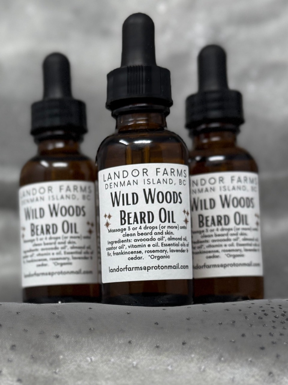 Wild Woods Beard Oil: three amber glass dropper bottles with black droppers and white Landor Farms labels